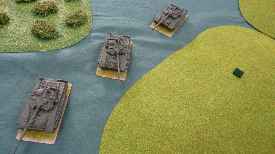 Soviet tanks move around the base of the ridge